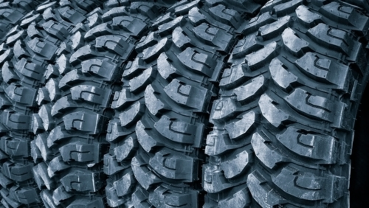 Close up of an advanced tyre tread compound with deep grooves for wet grip